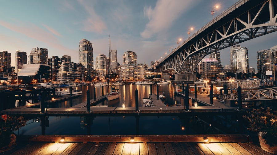 Vancouver City center and its modern buildings and bridge across Fraser River at night
