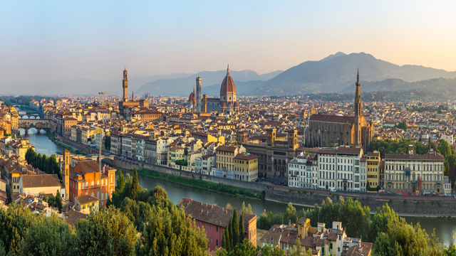 Aerial view of Florence featuring the historic Ponte Vecchio with its iconic medieval bridge spanning the Arno River