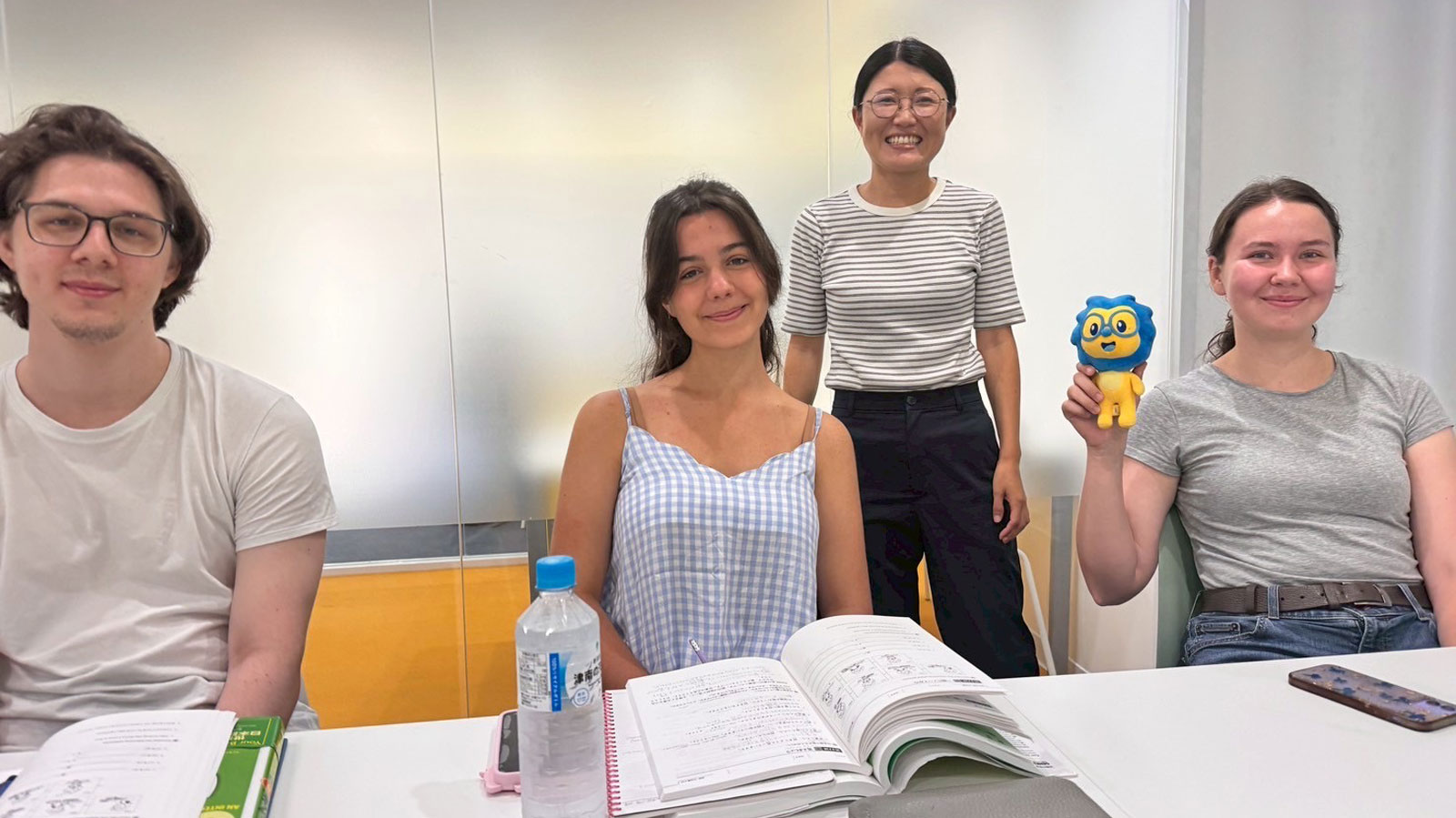 Three students with their teacher at LTL Tokyo