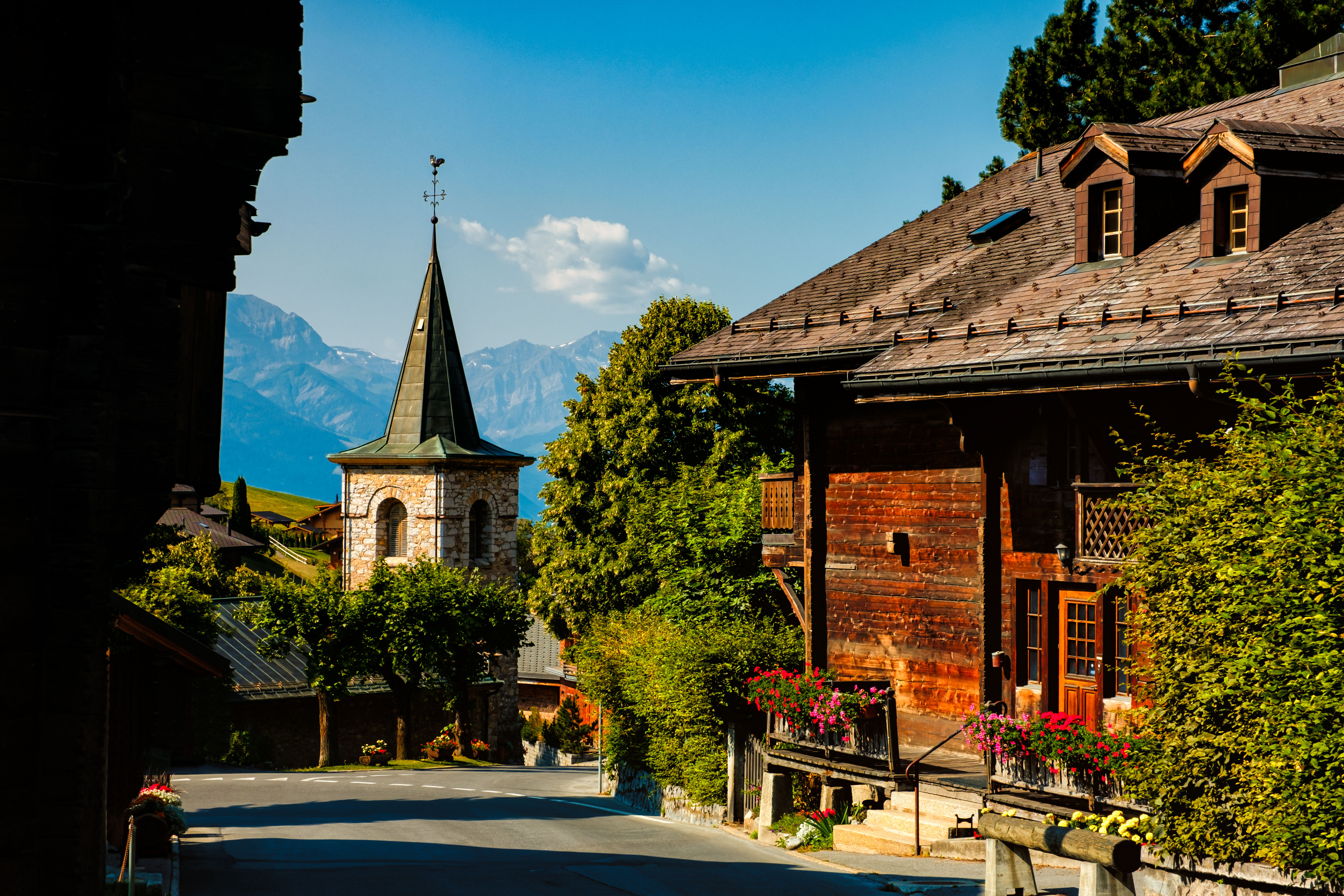 Street view in the picturesque municipality of Leysin, canton of Vaud near Aigle, Switzerland, on a bright sunny summer day with clear blue skies