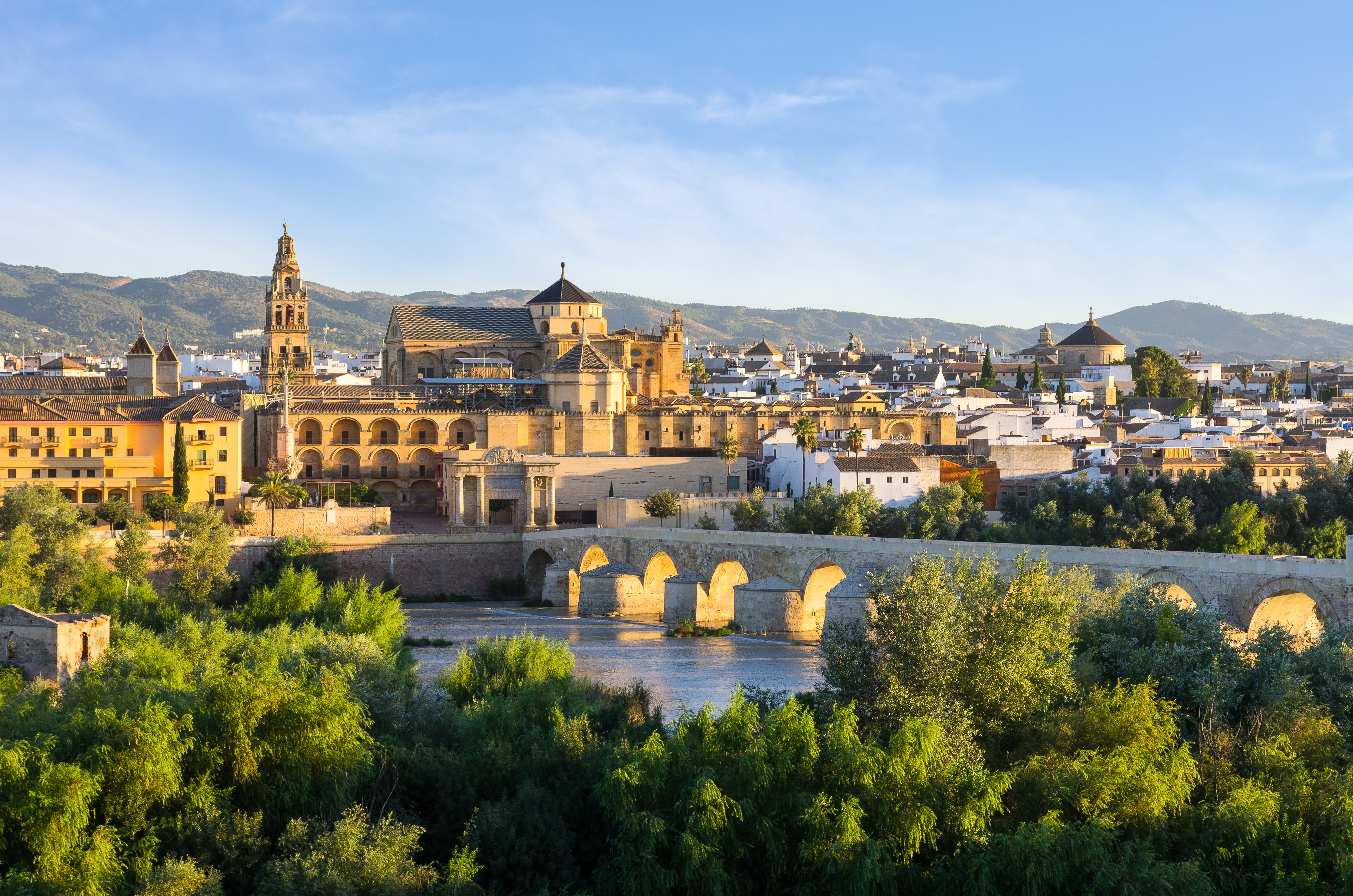 City center of Córdoba, Spain showing the Guadalquivir River, the Roman Bridge, and historic buildings including the Mezquita-Catedral