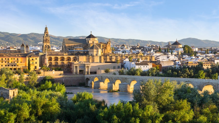 City center of Córdoba, Spain showing the Guadalquivir River, the Roman Bridge, and historic buildings including the Mezquita-Catedral
