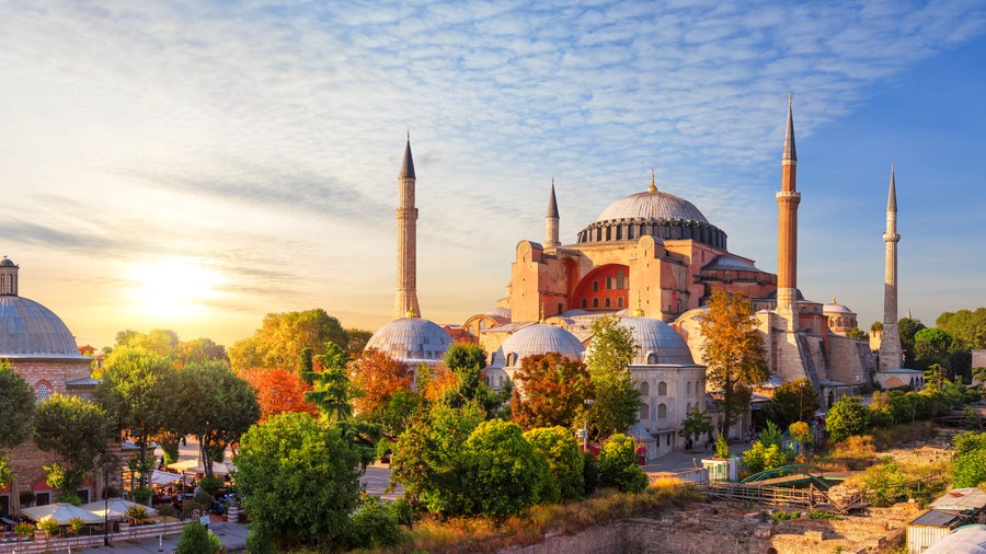 Blue Mosque (Sultan Ahmed Mosque) in Istanbul at sunset, with illuminated domes, six minarets, and colourful sky