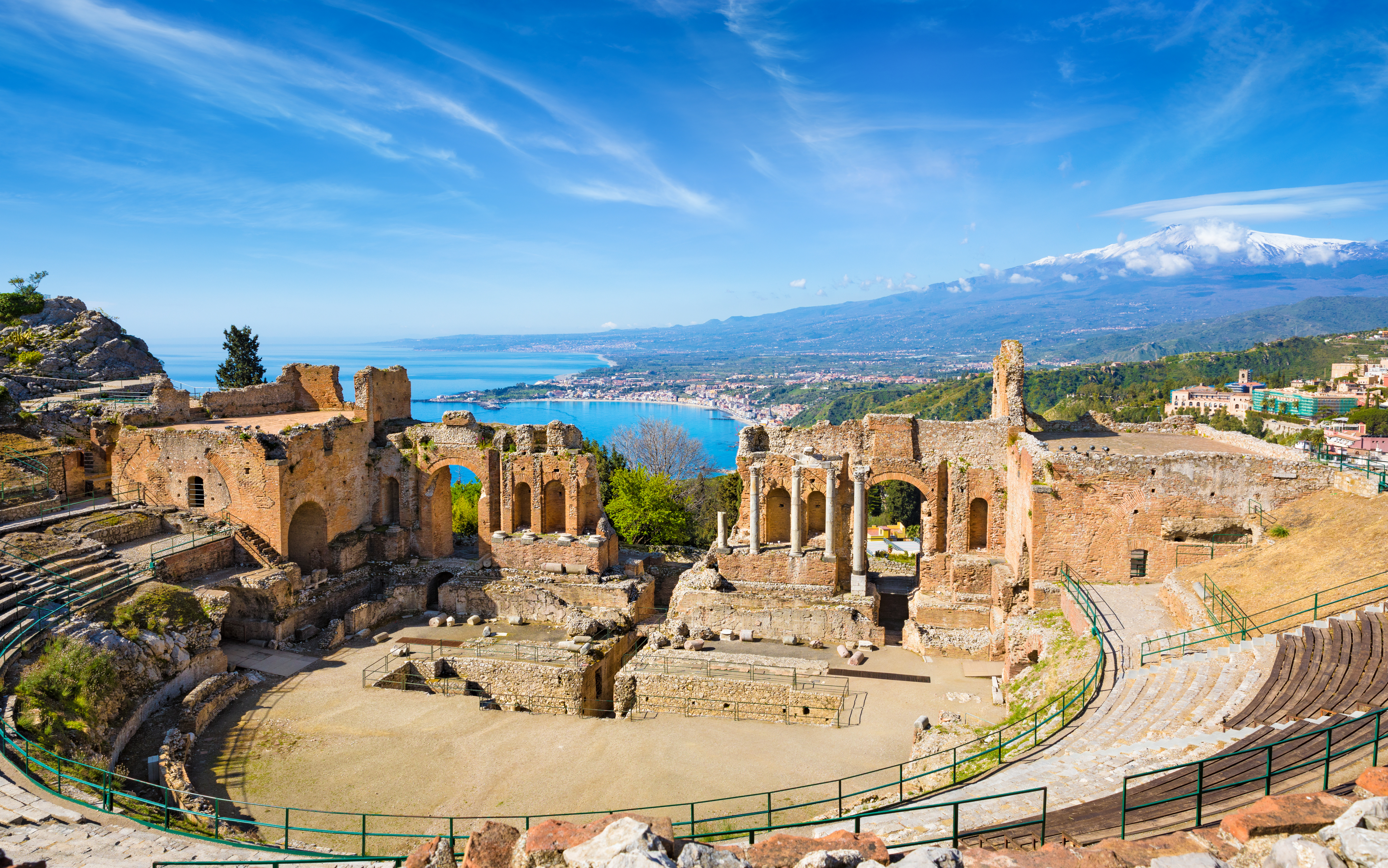 An aerial view of the ancient Greek theatre, semicircular stone amphitheater, in Taormina, Italy
