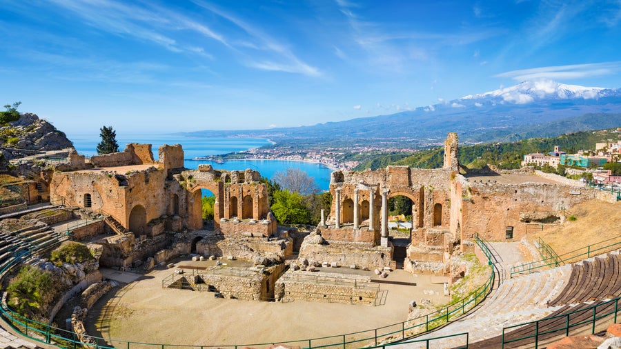 An aerial view of the ancient Greek theatre, semicircular stone amphitheater, in Taormina, Italy