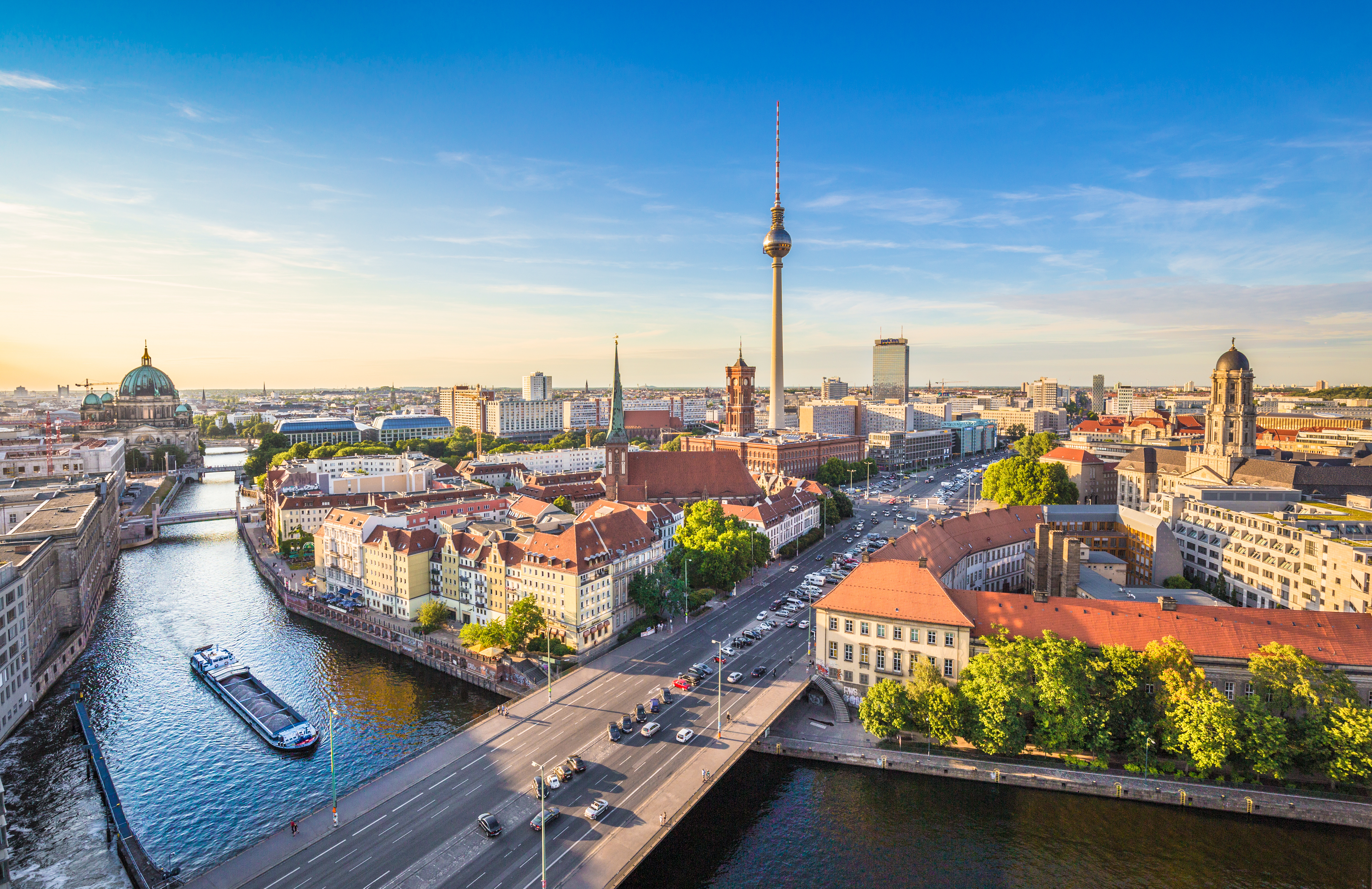 Panoramic high-angle view of Berlin skyline with TV Tower and Spree River at sunset, showcasing Germany’s iconic cityscape