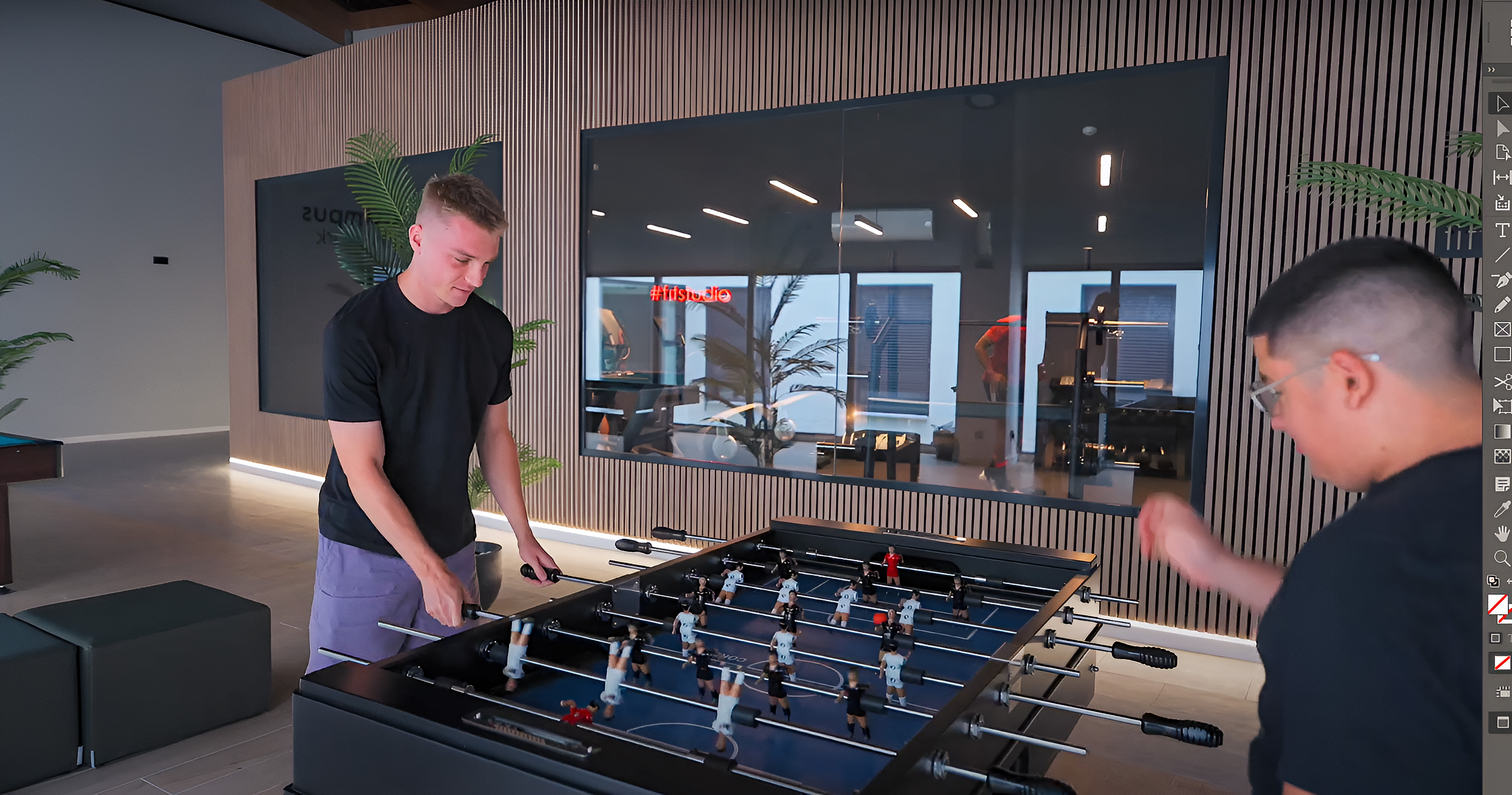 Two students playing foosball