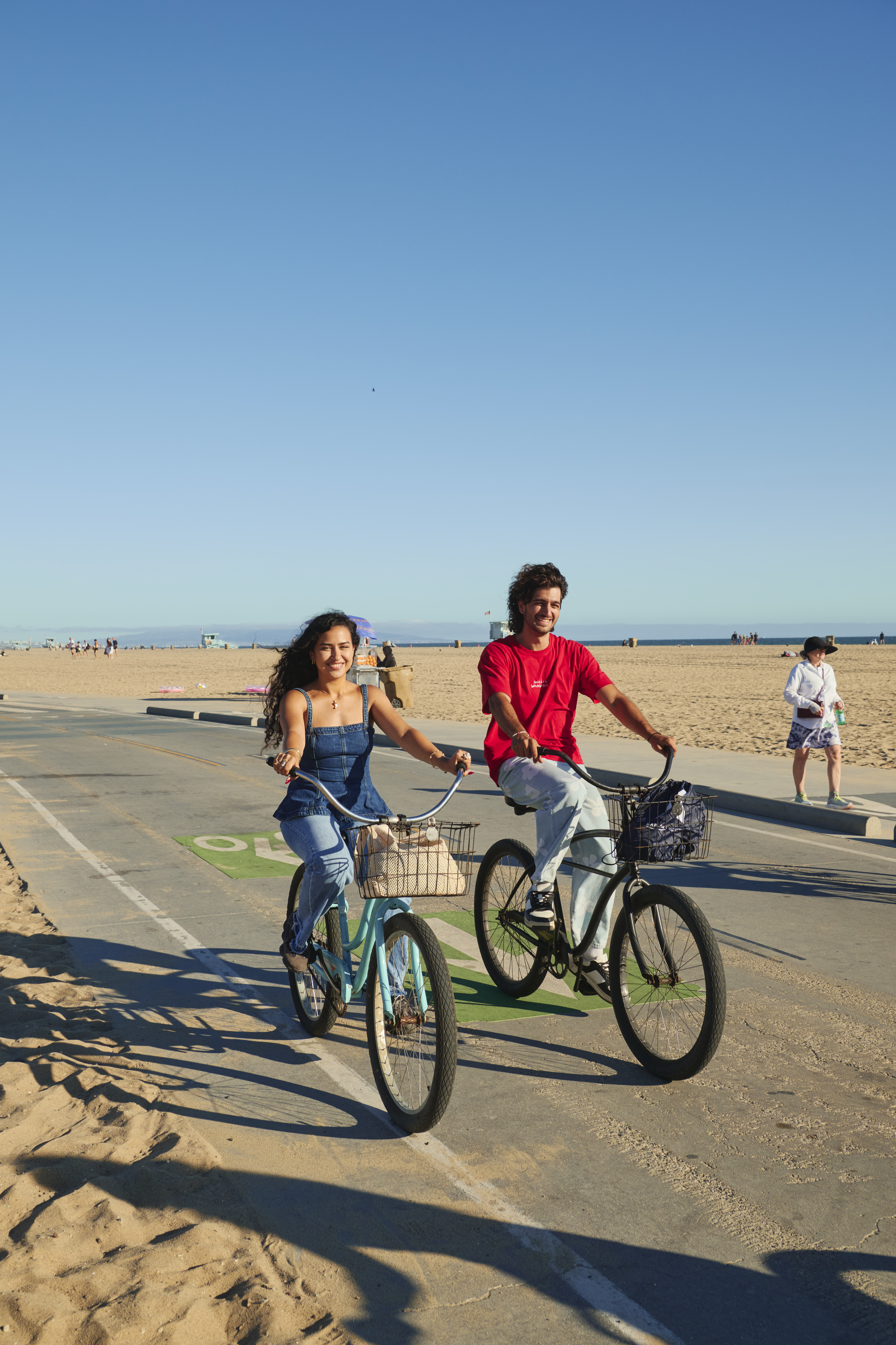 Kaplan International teen students riding bikes along the seaside