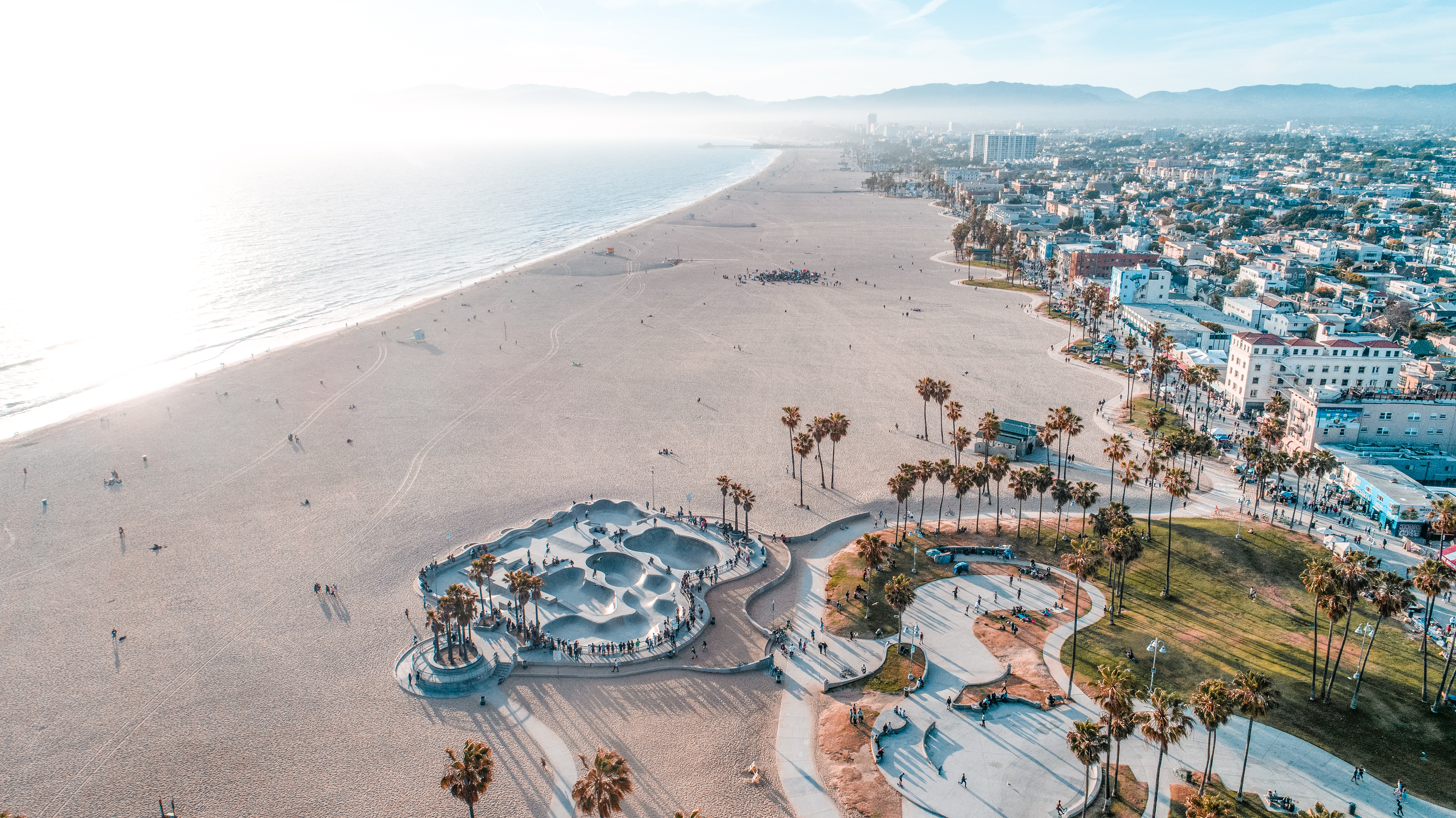 Venice Beach aerial view in Los Angeles, California with coastline, surf, and vibrant beach activity