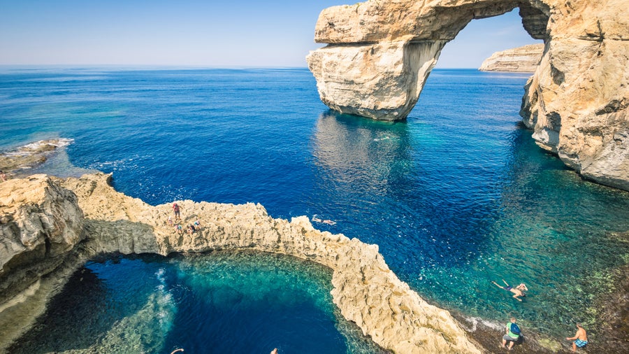 Salina Bay Malta natural rock sea pools with crystal-clear water and coastal landscape