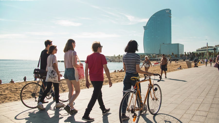 A group of students walking by the beach