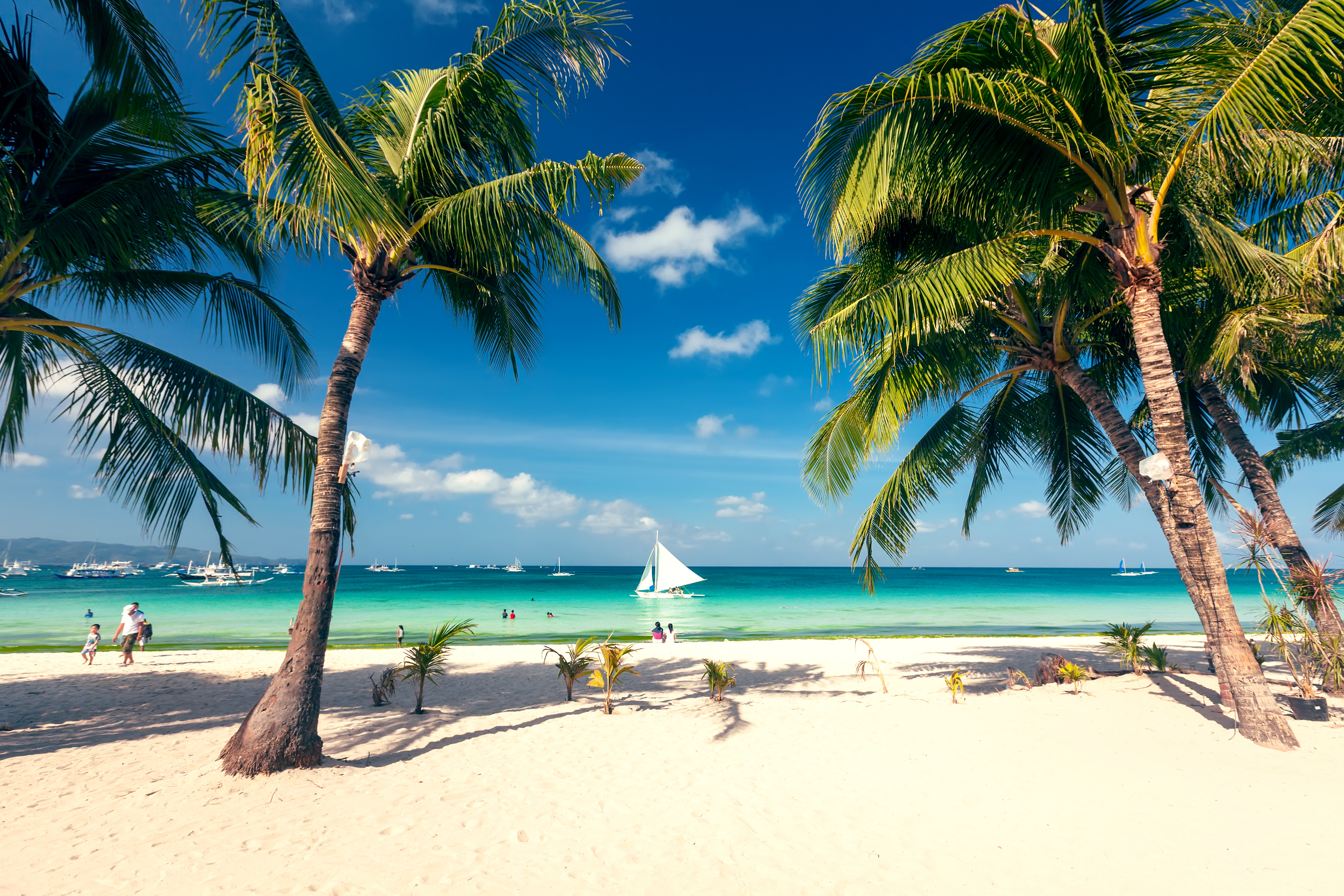 Pristine white sandy beach with clear turquoise waters at Boracay Island, Philippines