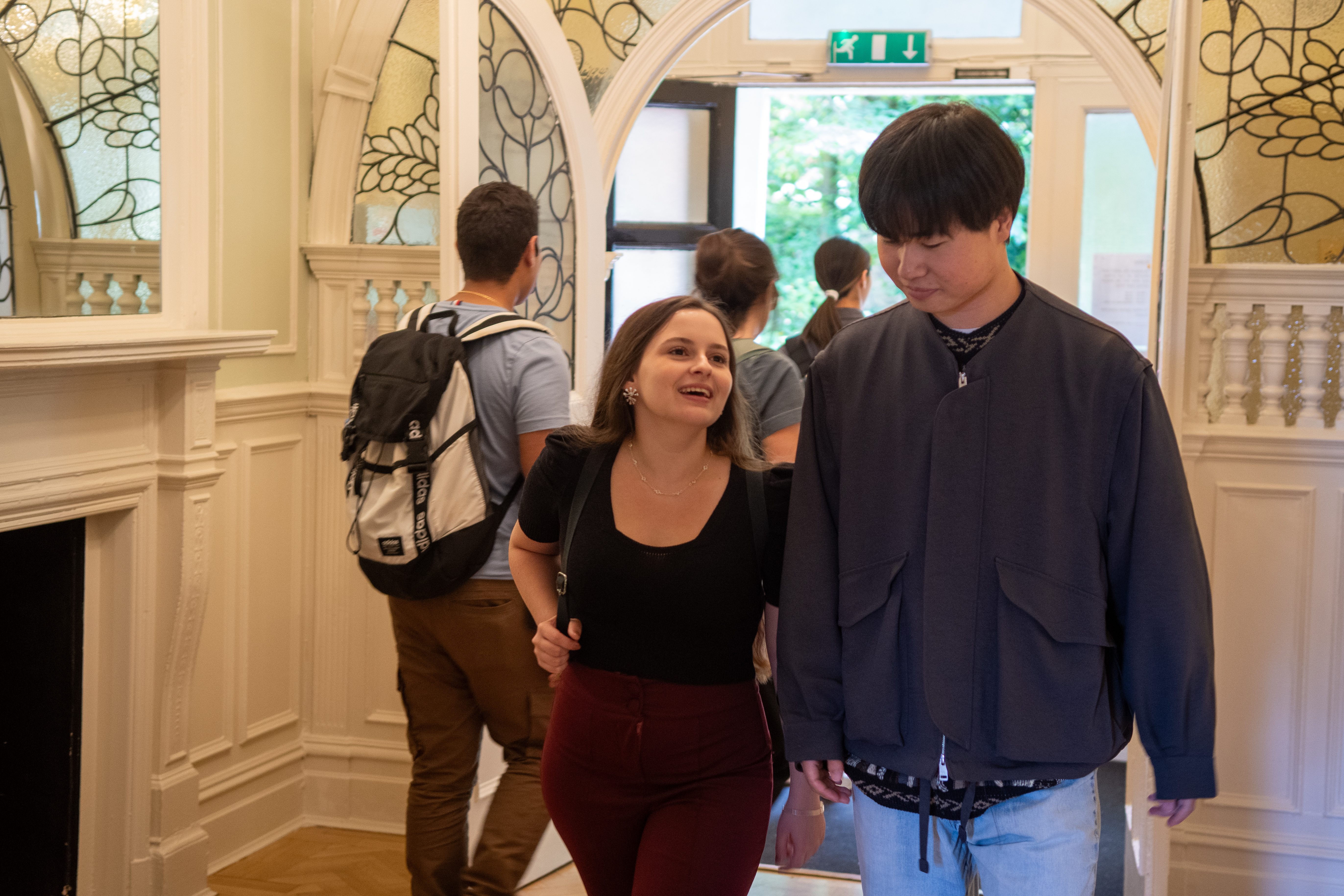 Two students walking through the hallway at London Highgate College Programme
