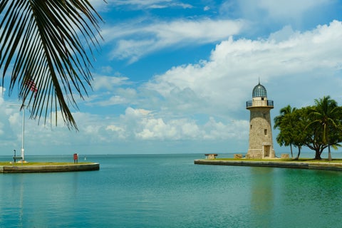 Cape Florida Lighthouse in Miami with coastal scenery and clear blue sky
