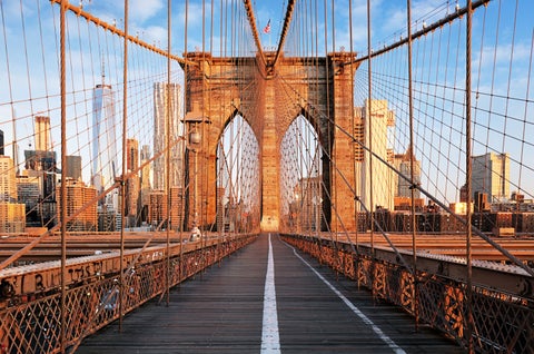 Brooklyn Bridge at sunrise with Manhattan skyline in New York City, USA