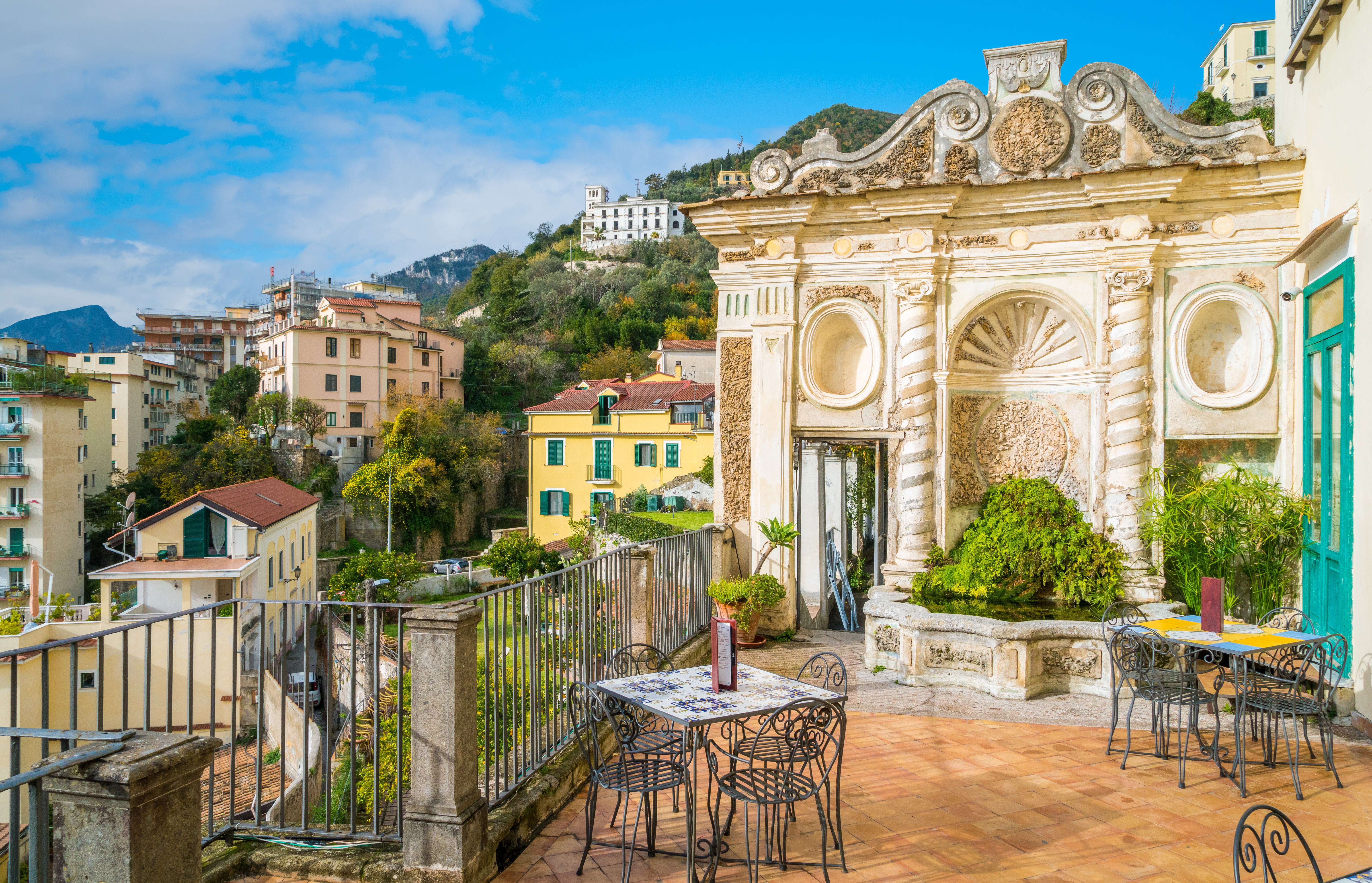 Traditional balcony in Salerno city center, Italy, with wrought iron railing and historic facade