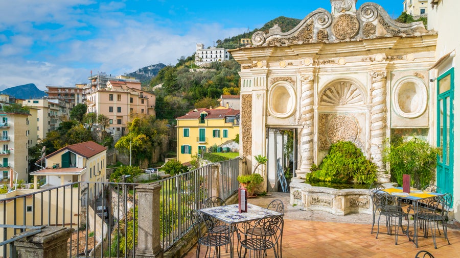 Traditional balcony in Salerno city center, Italy, with wrought iron railing and historic facade