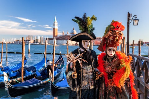 Couple dressed in colorful Carnival costumes in Venice, Italy