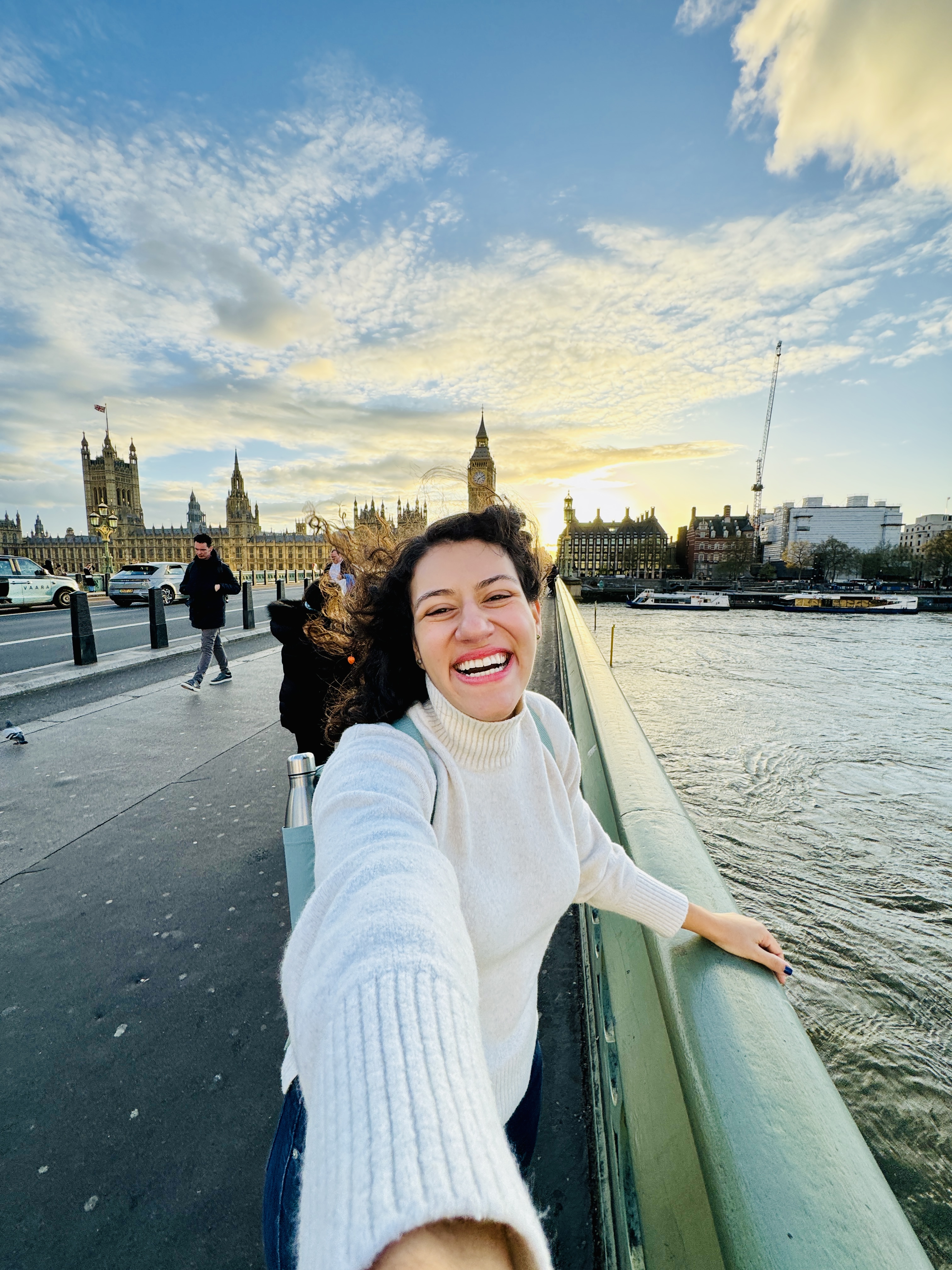 Exchange student posing by the River Thames with Big Ben in the background while studying English abroad in London