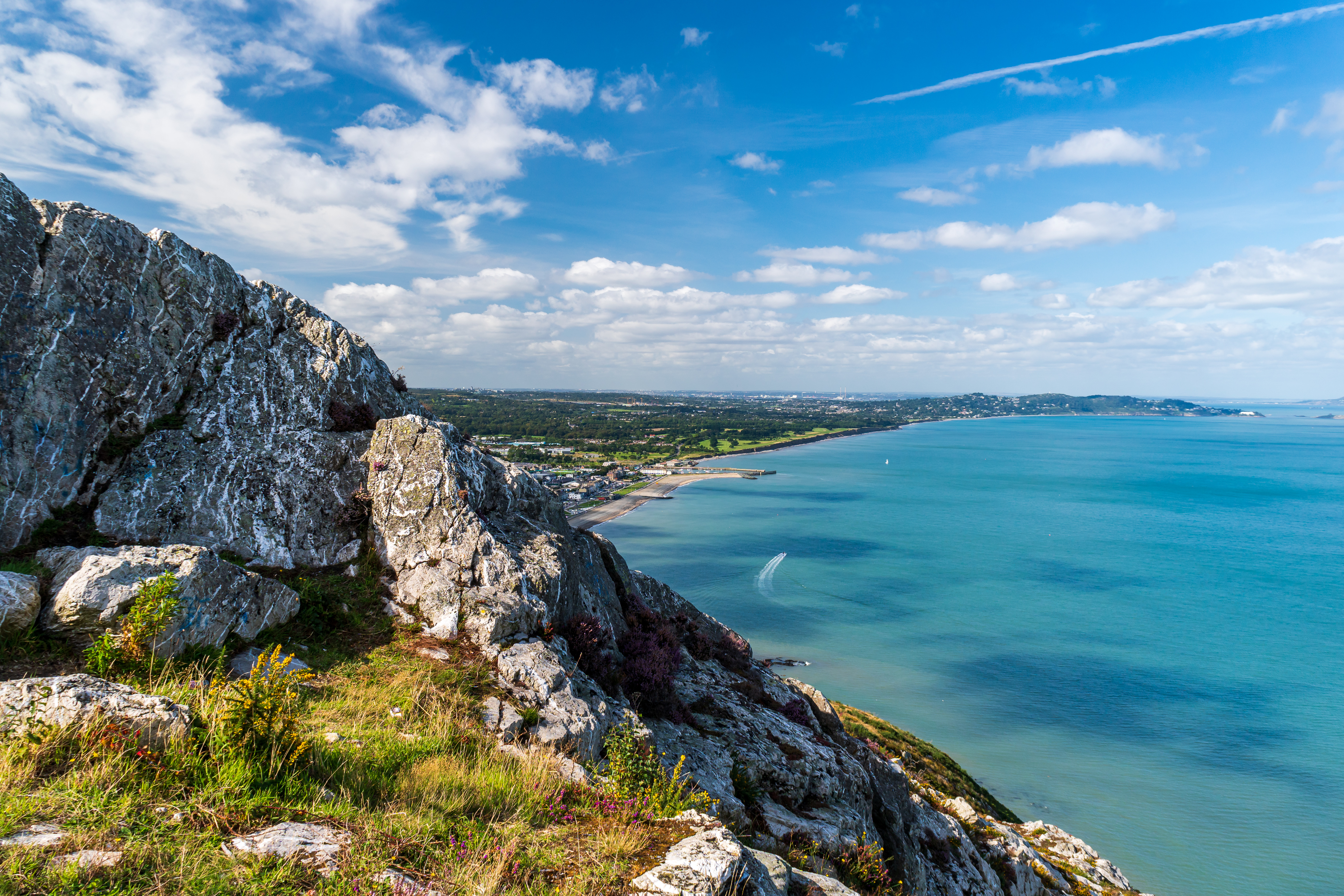 Jagged cliffs and turquoise sea at Bray Head, Wicklow, Ireland, capturing the colorful Irish coastal summer landscape