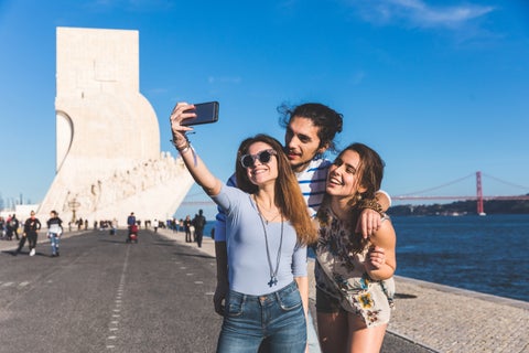 Tourists taking a selfie in front of the Monument to the Discoveries (Padrão dos Descobrimentos) in Lisbon, Portugal