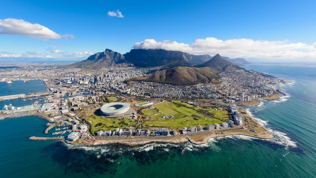 Aerial view of Cape Town featuring Table Mountain, coastline, and vibrant cityscape