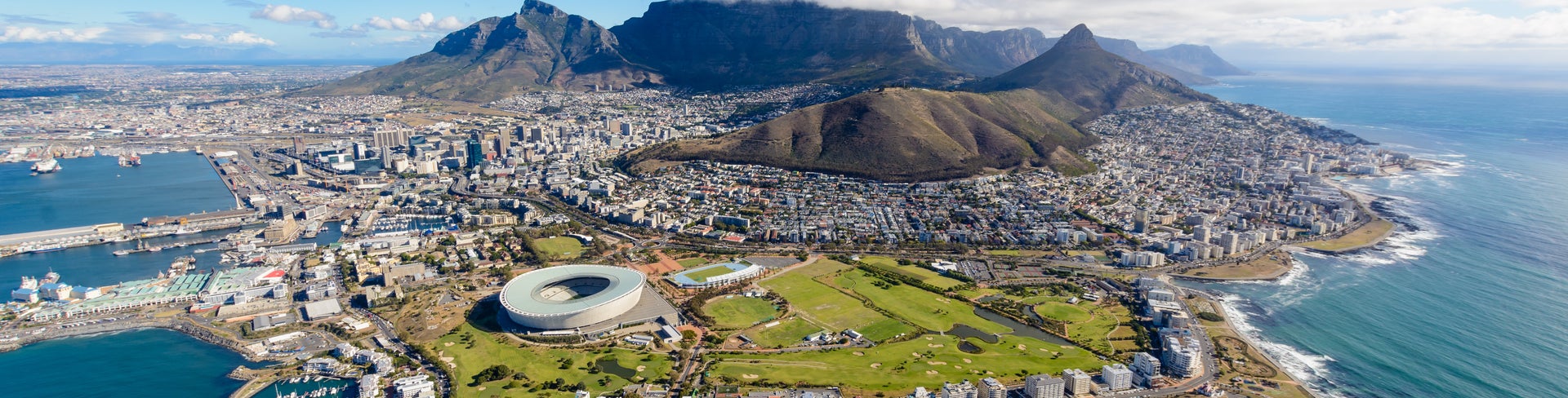 Aerial view of Cape Town featuring Table Mountain, coastline, and vibrant cityscape