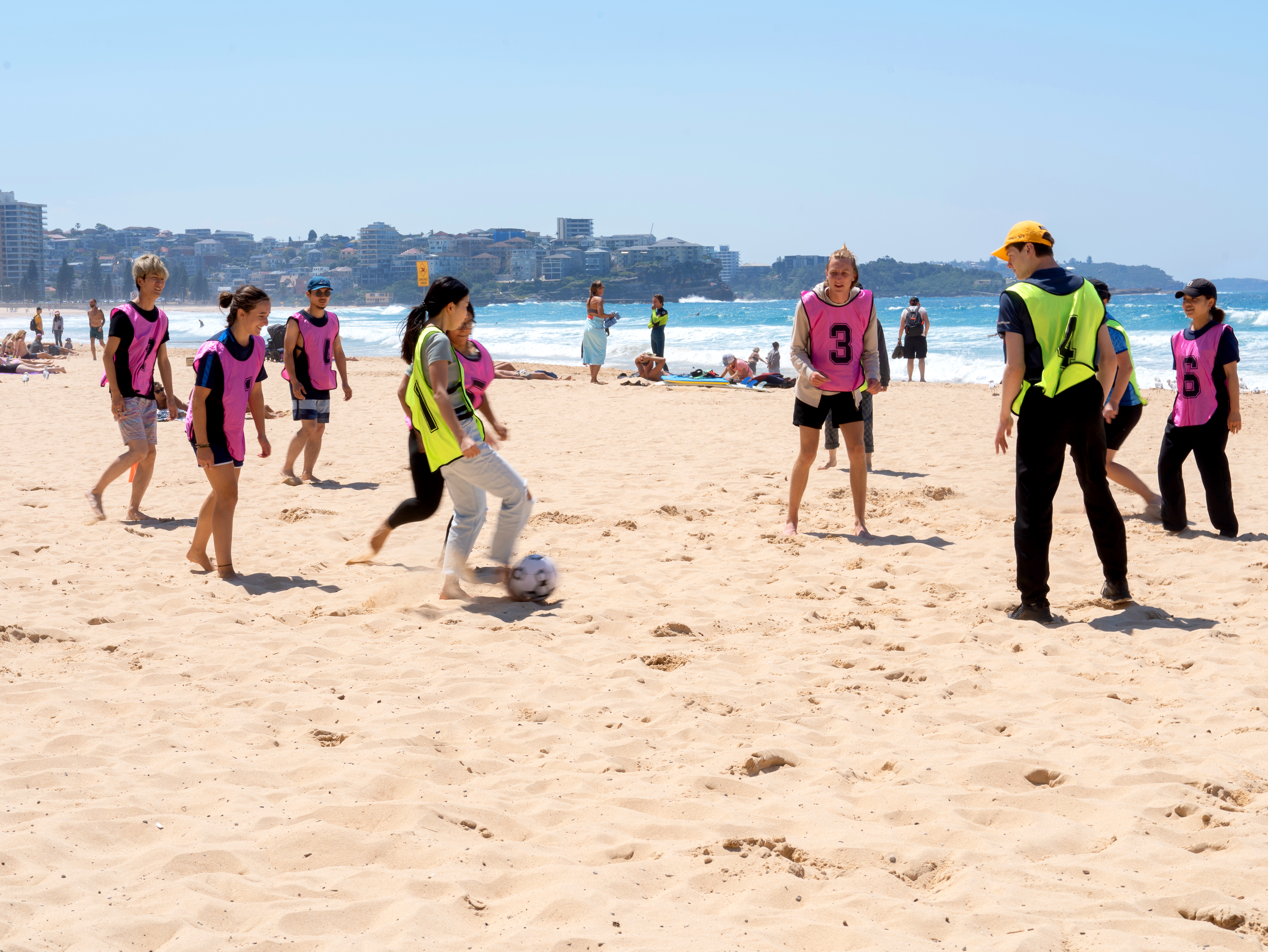 A group of students playing at the beach