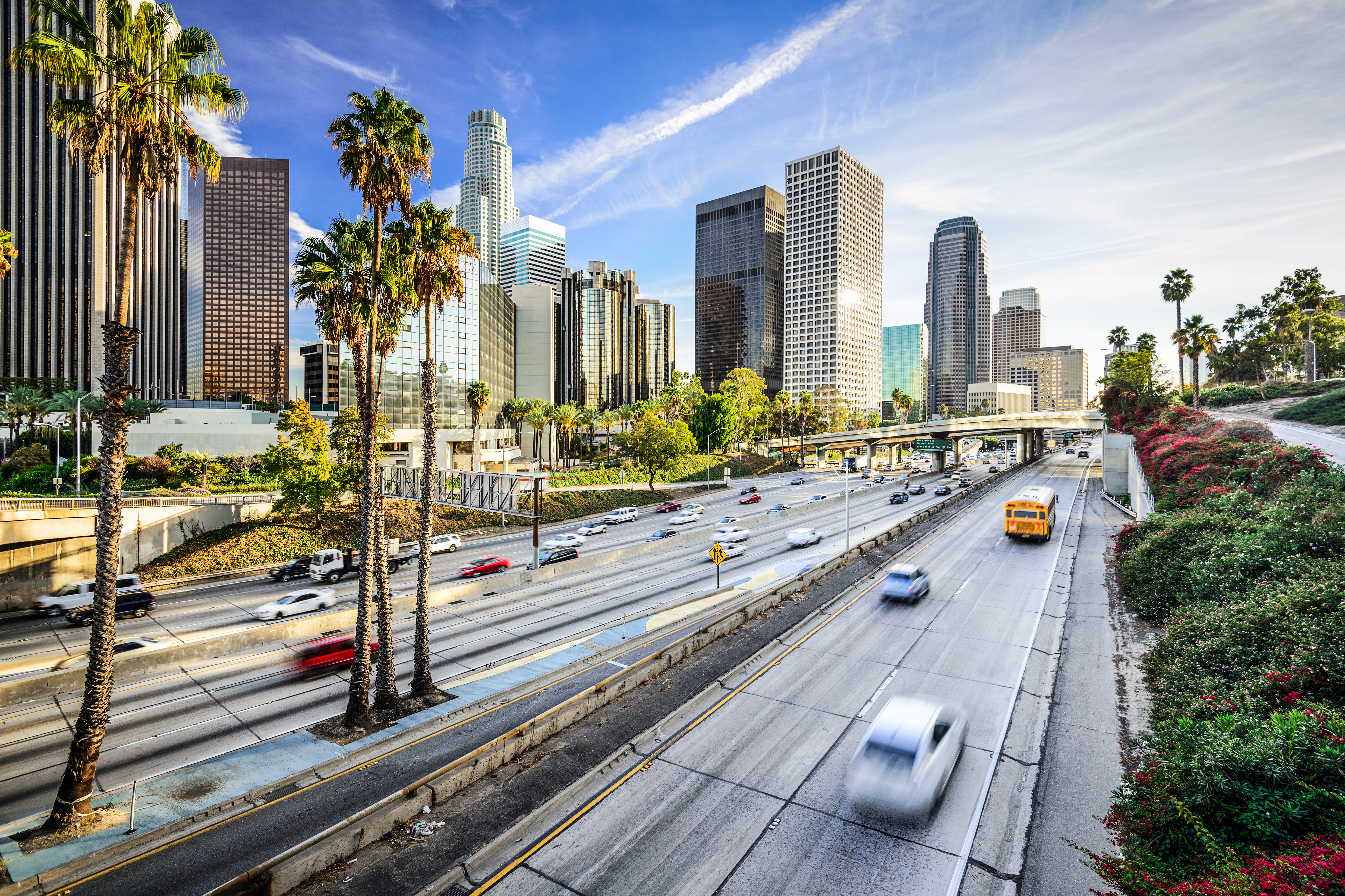 Los Angeles California skyline over highway with skyscrapers and urban cityscape
