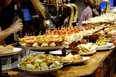 Food buffet featuring a variety of dishes at a restaurant in San Sebastián, Spain