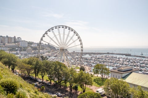 Aerial view of Torquay with Ferris wheel and harbour on a sunny day, United Kingdom