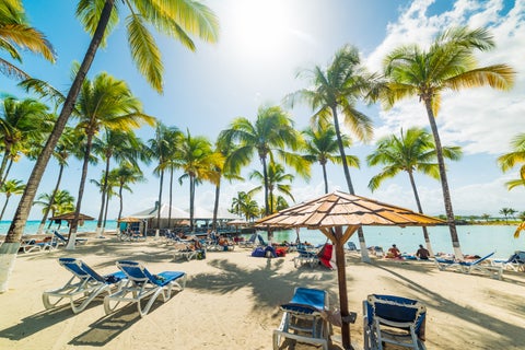 Beach chairs and parasol in Bas Du Fort beach in Guadeloupe