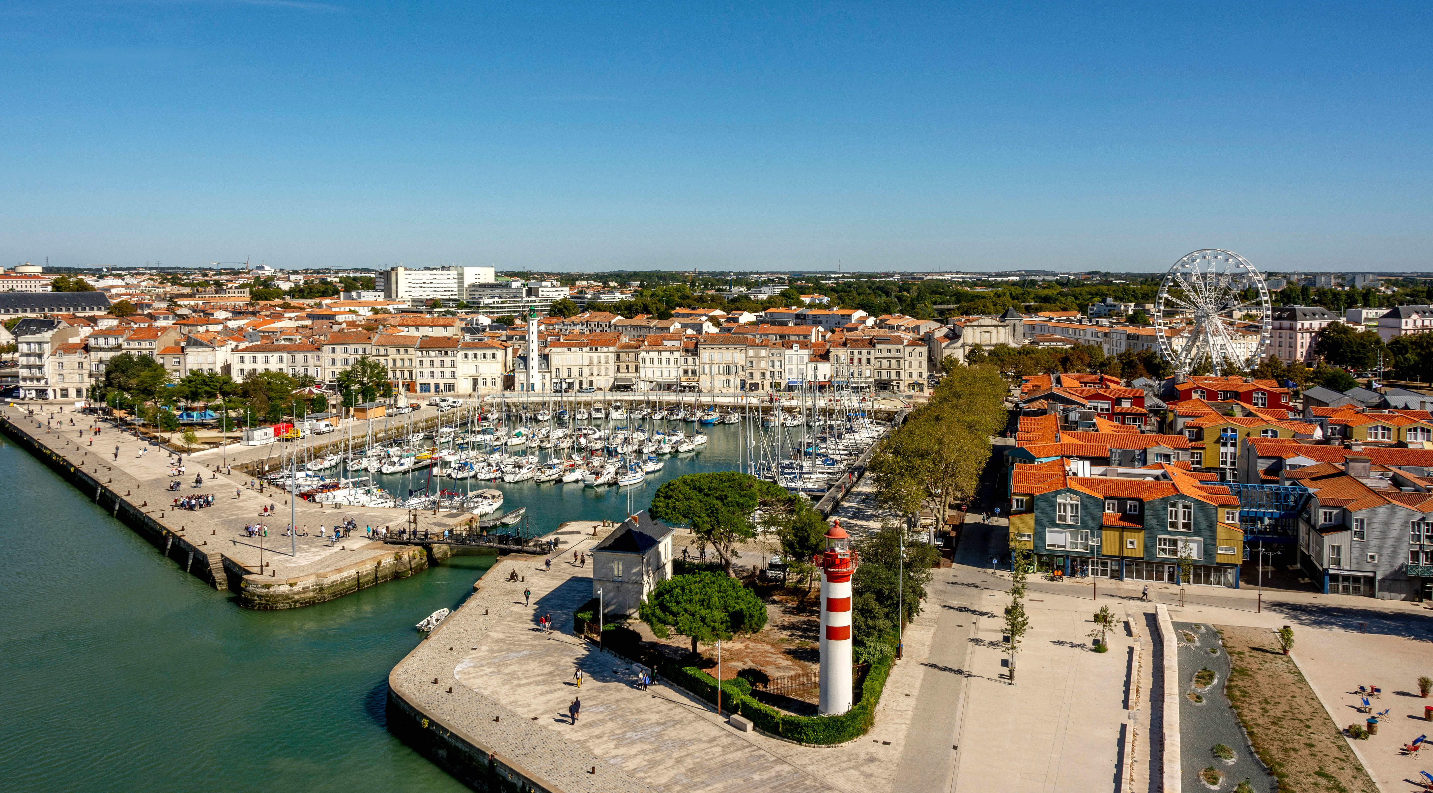 Aerial view of La Rochelle City featuring its Harbour, historic buildings, Ferris Wheels