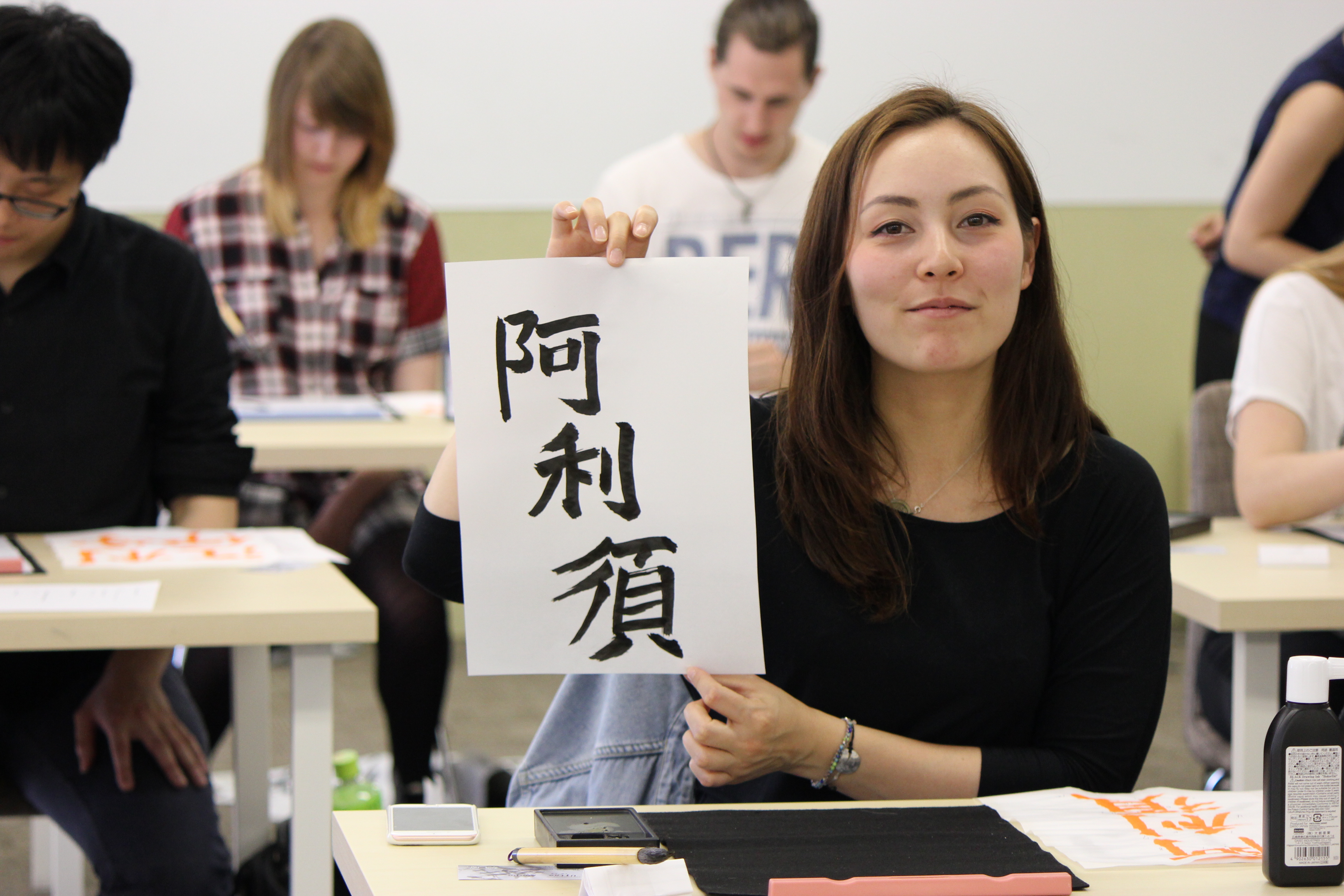 A student showing her calligraphy exercise