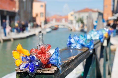 Bridge with flowers at Venice with its famous canal in the back, Italy