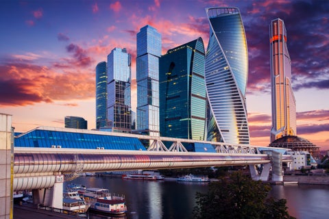 Boats on the Moskva River below the Bagration Bridge with modern buildings in Moscow, Russia