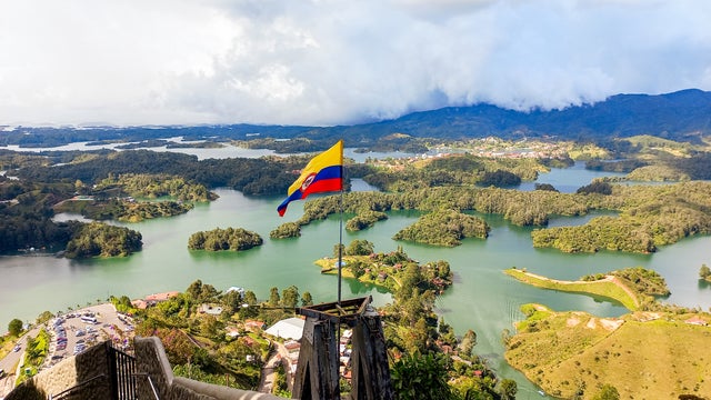 Colombian flag waving proudly over the picturesque Lake Guatapé