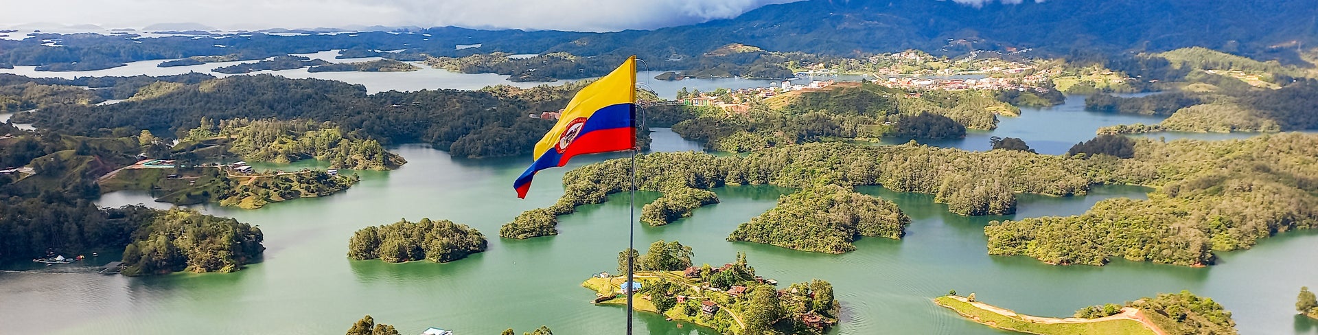 Colombian flag waving proudly over the picturesque Lake Guatapé