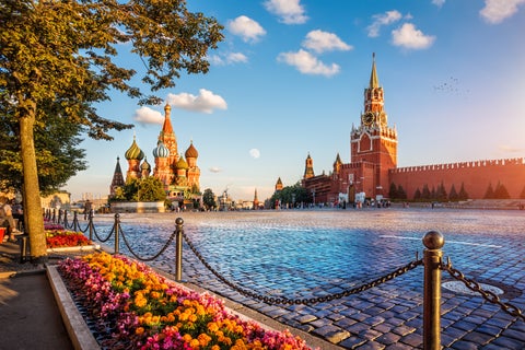 Colourful domes of St. Basil's Cathedral with the historic GUM Department Store next to it in Moscow, Russia