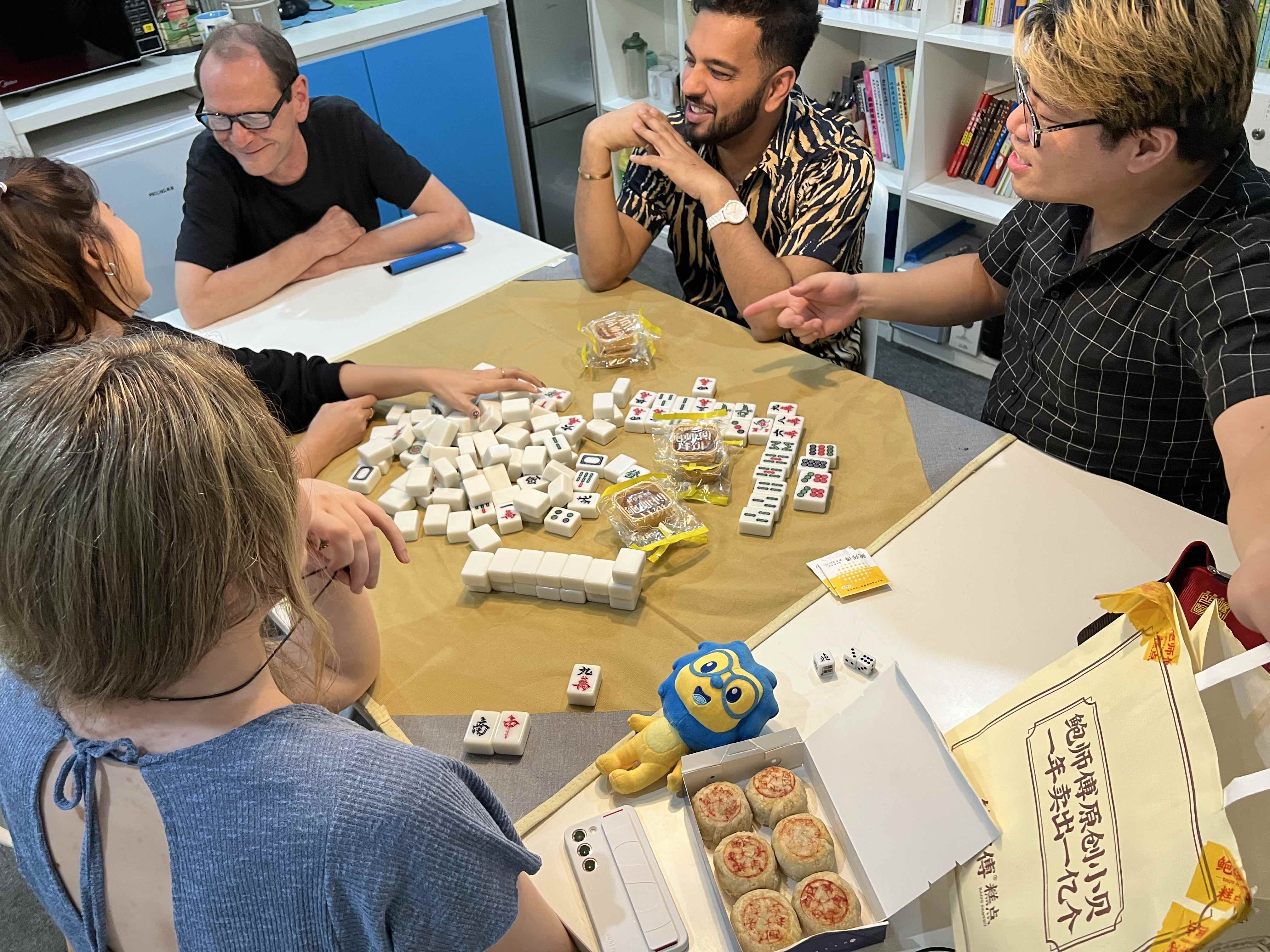A group of students playing Mahjong