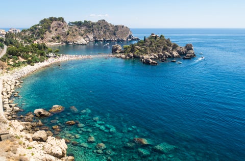 Aerial view of Taormina beach, Italy, with turquoise waters, sandy shoreline