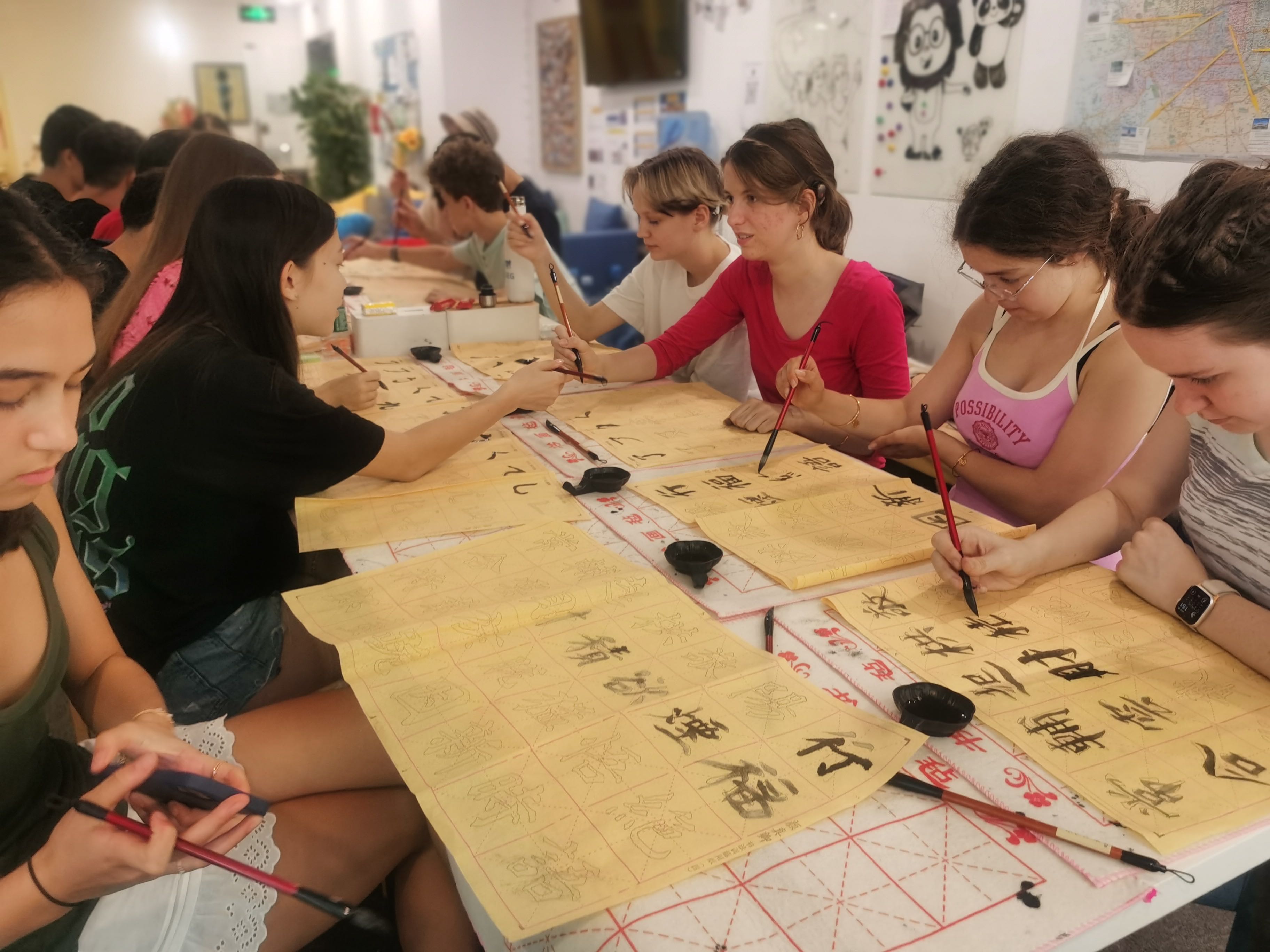 Students in classroom doing calligraphy excercices