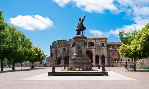 Statue of Juan Pablo Duarte in Parque Independencia with the historic Alcázar de Colón in the background, Santo Domingo, Dominican Republic