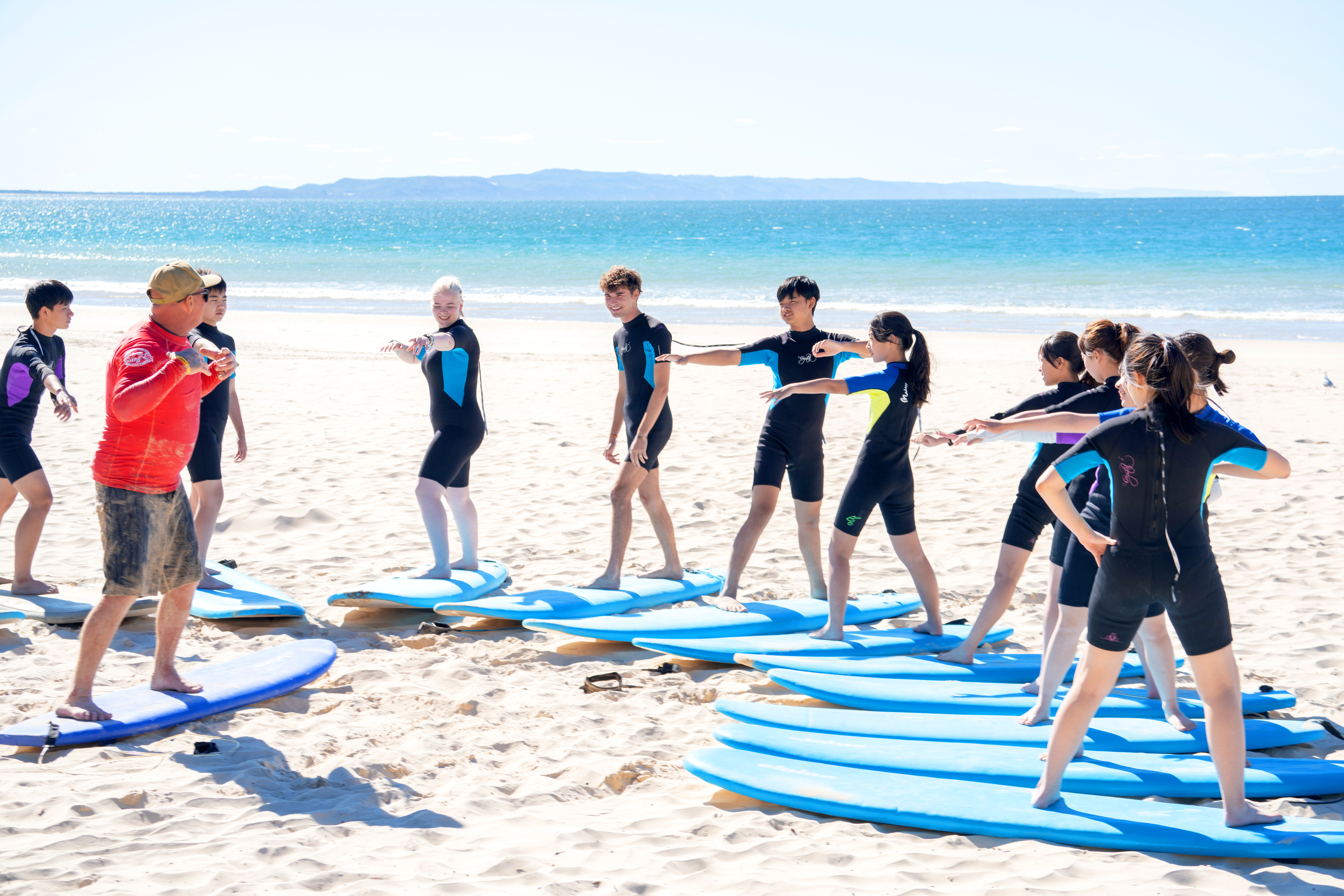 A group of students at a surf lesson