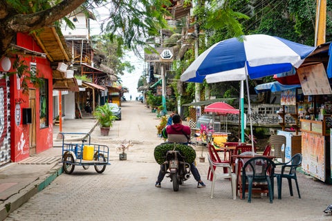 Motorcycle next to bars in the streets of Montañita, Ecuador