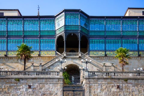 Casa Lis in Salamanca, Spain, a modernist building with a colorful, purple-toned façade and stained-glass windows