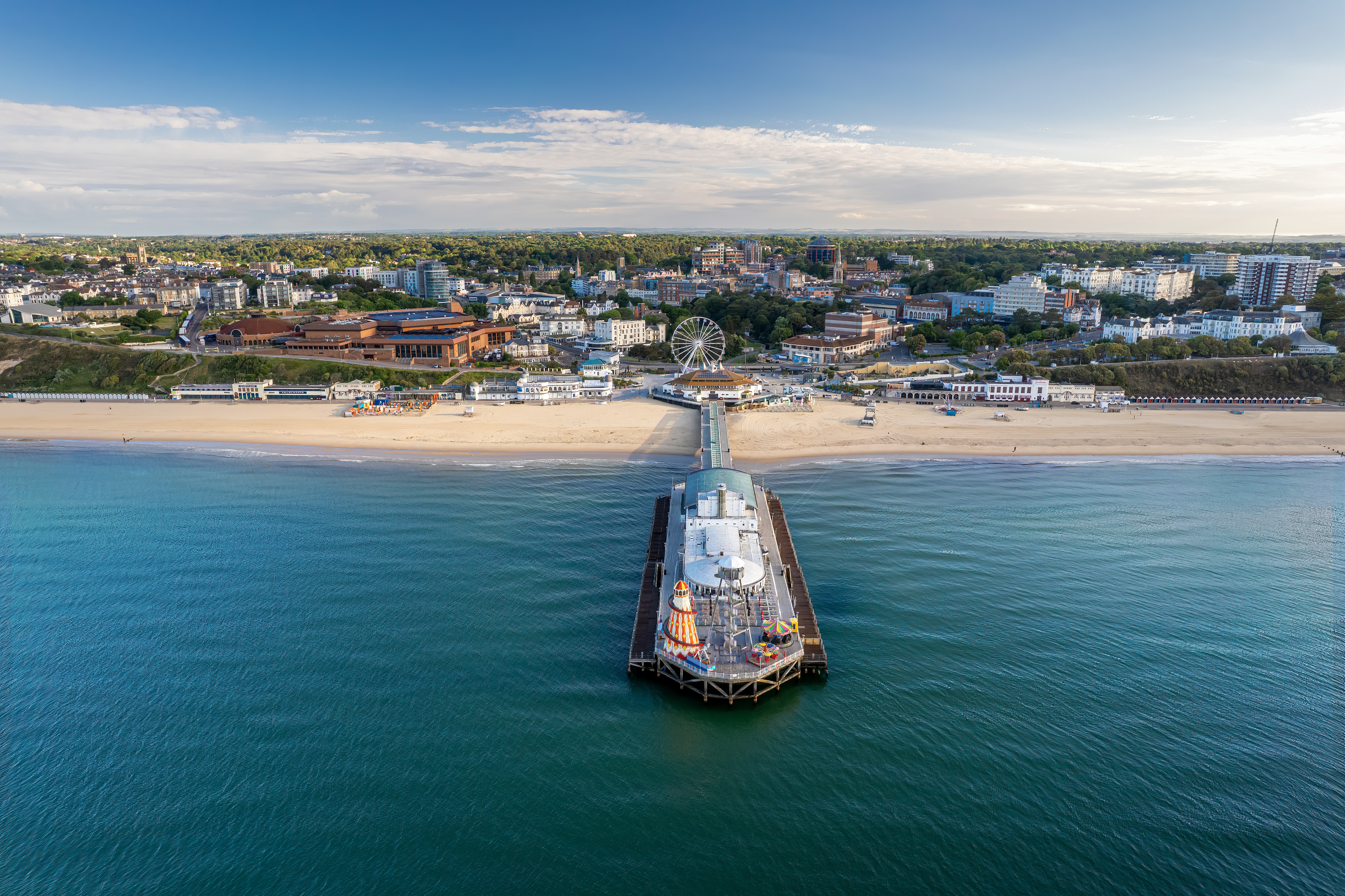 Drone aerial view of Bournemouth Beach, Pier, and Observation Wheel in Dorset, England, showcasing the coastal town