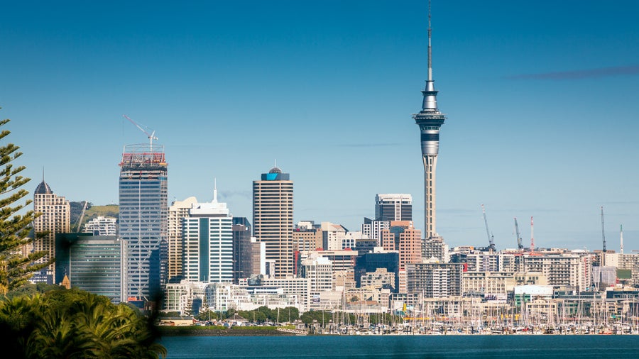 Auckland CBD skyline with Sky Tower, modern high-rises, and Waitematā Harbour in the background