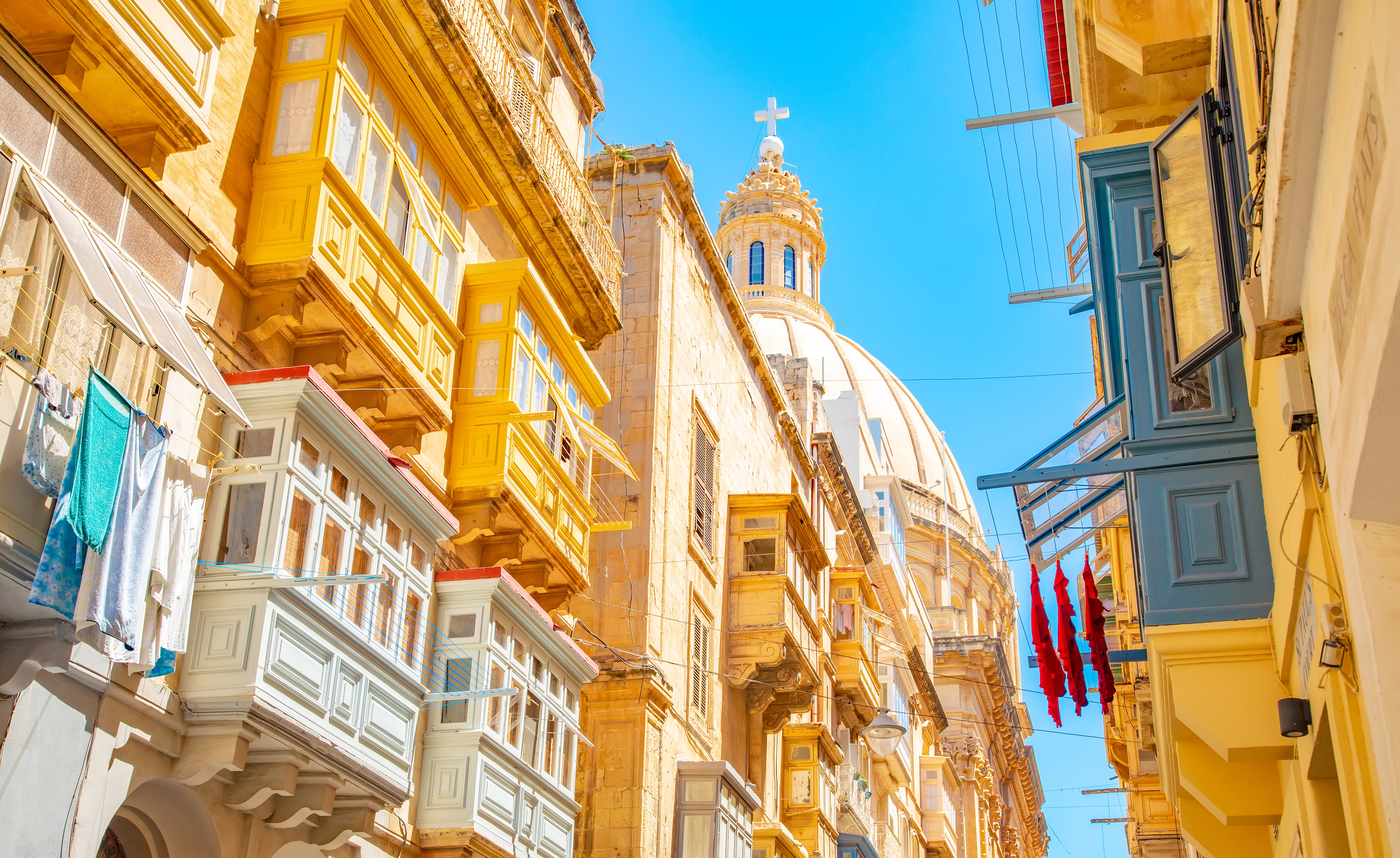 Narrow street with colourful balconies in Valletta old town, Malta