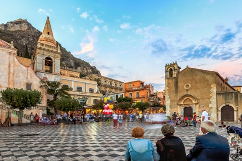 Tourists exploring Taormina Historic City center in Italy